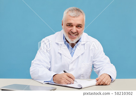 Doctor working at his workplace 58210302