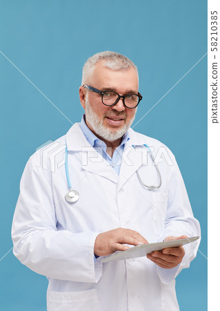 Skilled doctor with digital tablet Skilled doctor with digital tablet 58210385