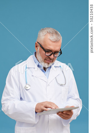 Mature doctor with tablet pc Mature doctor with tablet pc 58210438