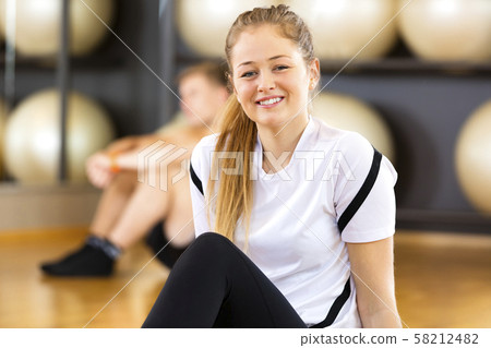 Close-up portrait of a smiling woman at fitness center 58212482
