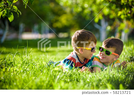 Happy smiling boy sibling brother relaxing on the 58213721