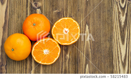 Orange fruit on a wooden table. Orange fruit on a wooden table. 58215483