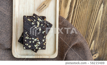 Brownies cake and fork on a wooden table. 58215489