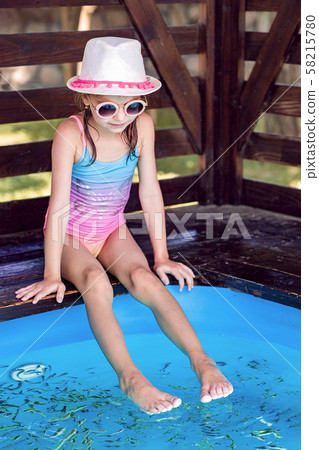 Young girl receiving massage with small fishes. Peeling with fish. Girl enjoying medicinal procedure Young girl receiving massage with small fishes. Peeling with fish. Girl enjoying medicinal procedure 58215780