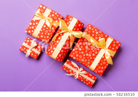 Top view Christmas present box with gold bow on Top view Christmas present box with gold bow on 58216510