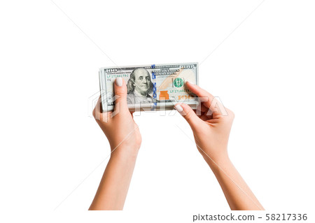 Female hand giving a bundle of dollar bills on 58217336