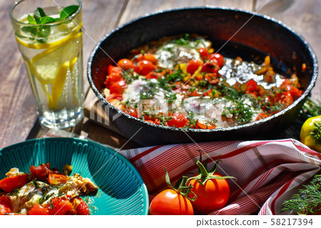 fried eggs with vegetables in a pan fried eggs with vegetables in a pan 58217394
