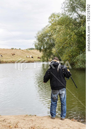 Fisherman fishes on the lake 58219702