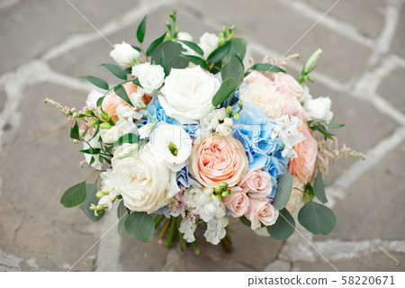 Bouquet of roses, hydrangeas, carnations, eustoma in on a concrete background, vintage style. 58220671