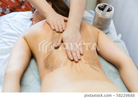 Massage and clean the skin with a body scrub. Girl Massage and clean the skin with a body scrub. Girl 58220688