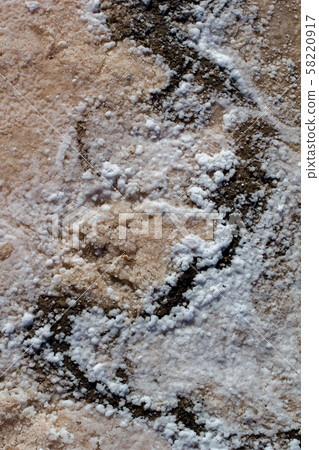 Natural white salt crystal texture on the sand, macro, close up. Natural white salt crystal texture on the sand, macro, close up. 58220917