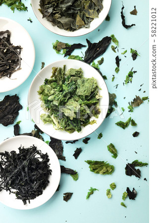 Seaweed, sea vegetables, shot from above on a blue background Seaweed, sea vegetables, shot from above on a blue background 58221012
