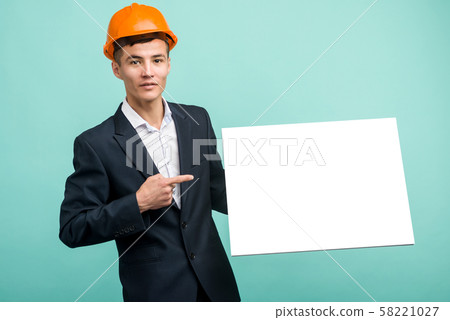 Happy smiling young asian engineer man points Happy smiling young asian engineer man points 58221027
