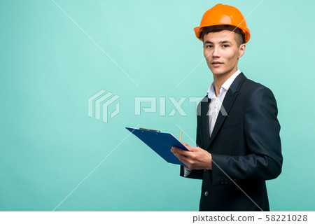 A young professional wearing a hard hat and A young professional wearing a hard hat and 58221028