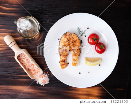 Top view with a piece of salmon arranged in a white plate Top view with a piece of salmon arranged in a white plate 58221503