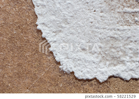 Natural white salt crystal waves texture on the sand, macro, close up. Salty lake shore background 58221529