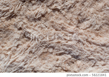 Natural pink salt crystal texture on the sand, macro, close up, lamellar structure. Salty lake shore background 58221841