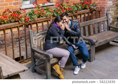 young man and woman whisper about something and young man and woman whisper about something and 58222830