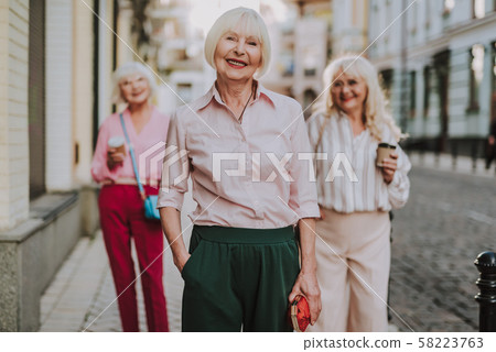 Beautiful old lady standing with hers friends Beautiful old lady standing with hers friends 58223763