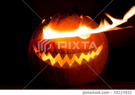 Spooky halloween pumpkin has hot fire flame eyes 58223932