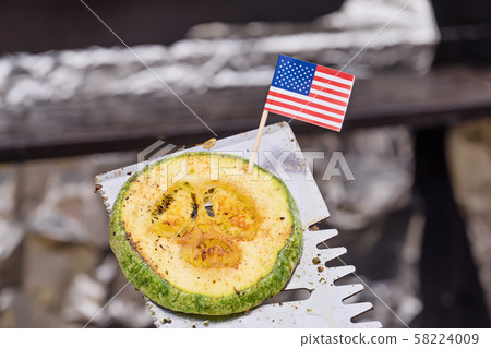 One grilled zucchini medallions on grill spatula 58224009