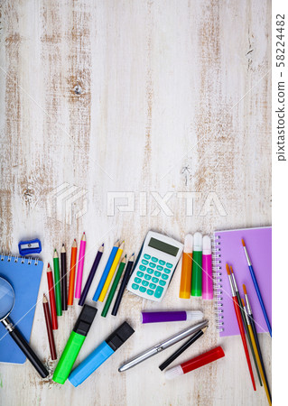 Items for the school on a wooden table. Items for the school on a wooden table. 58224482