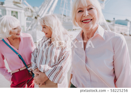 Nice older ladies are laughing together outdoor Nice older ladies are laughing together outdoor 58225256