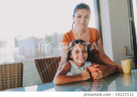 Pleasant mother enjoying time with her pretty daughter Pleasant mother enjoying time with her pretty daughter 58225512