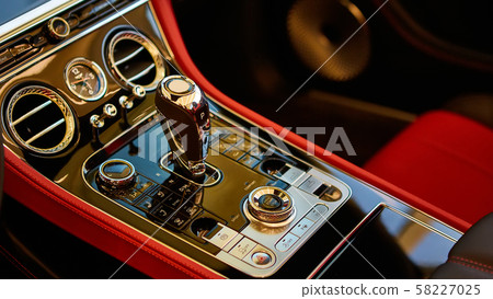 Automatic gear shift handle. Red luxury car Interior. Shallow doff. 58227025