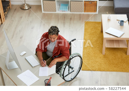 Disabled woman working at the table Disabled woman working at the table 58227544