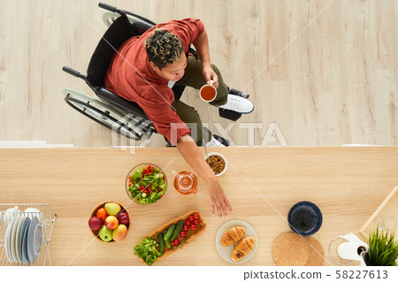 Disabled woman drinknig tea 58227613