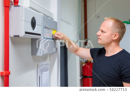 IT Engineer Opening Fire Panel In Server Room 58227713