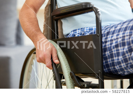 Senior man riding on wheelchair Senior man riding on wheelchair 58227815