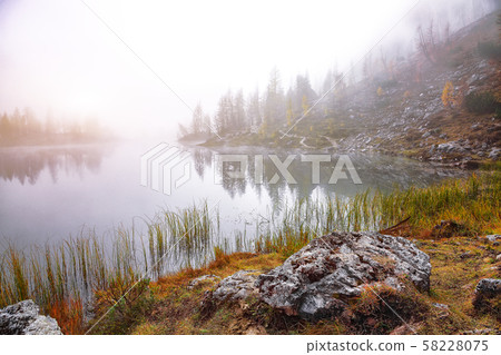 Dramatic foggy autumn landscape. View on Federa 58228075