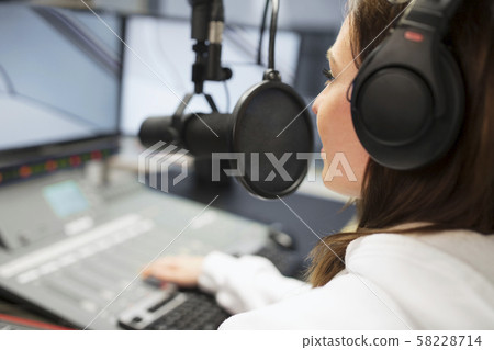 Jockey Wearing Headphones While Using Microphone In Radio Studio Jockey Wearing Headphones While Using Microphone In Radio Studio 58228714