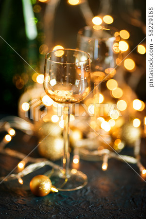 Glasses for wine and golden Christmas balls 58229168