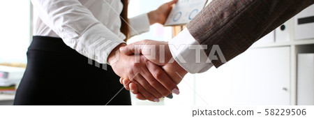 Man in suit and tie give hand as hello in office 58229506