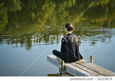 Meditation by the river. 58229624