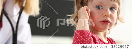 Little child with mother at pediatrician reception Little child with mother at pediatrician reception 58229627