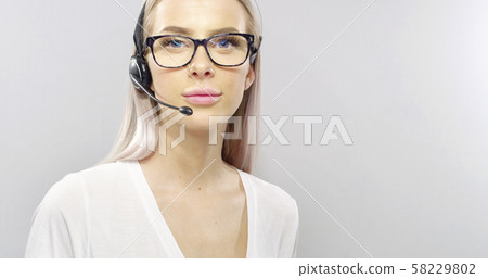 Close-up of a smiling customer service or support representative with headset Close-up of a smiling customer service or support representative with headset 58229802