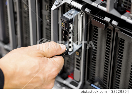 IT Engineer's Hands Repairing Server At Data Center 58229894