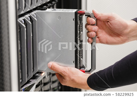 IT professional installs server cluster in large datacenter IT professional installs server cluster in large datacenter 58229925