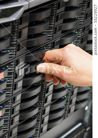 IT Engineer's Hand Installing Hard Drive At Data Center 58229927
