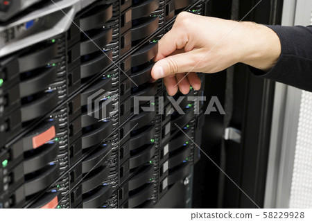 Male IT Technician's Hand Replacing Hard Drive In San Male IT Technician's Hand Replacing Hard Drive In San 58229928