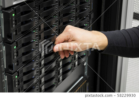 IT Engineer's Hand Replacing Hard Drive In Data Center IT Engineer's Hand Replacing Hard Drive In Data Center 58229930