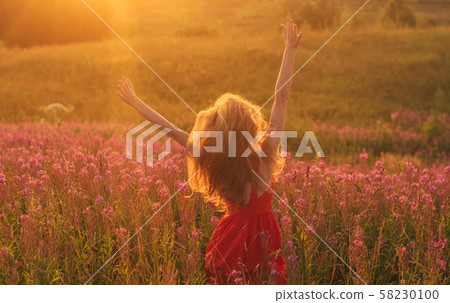 Dancing and jumping girl with hands up in red 58230100