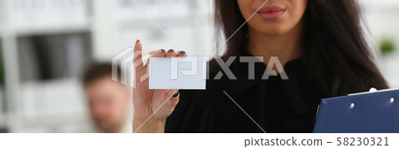 Female arm give blank calling card to visitor 58230321