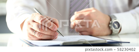 Male doctor hand hold silver pen filling patient history list Male doctor hand hold silver pen filling patient history list 58230402