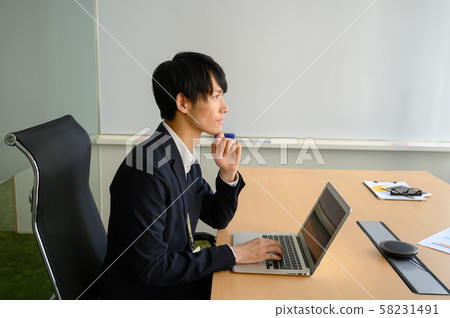 A businessman working on a computer A businessman working on a computer 58231491
