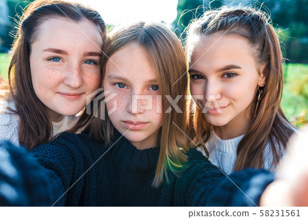 Girls teenagers close-up, 3 schoolgirls girlfriends, summer, autumn spring in city, taking pictures Girls teenagers close-up, 3 schoolgirls girlfriends, summer, autumn spring in city, taking pictures 58231561